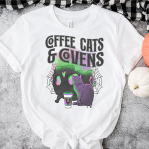 
            
                Load image into Gallery viewer, Coffee Cats and Covens $12 Graphic Tee (TEE1062)
            
        